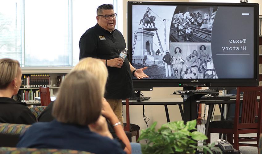 Joe Perez standing in front of the audience giving his presentation. 
